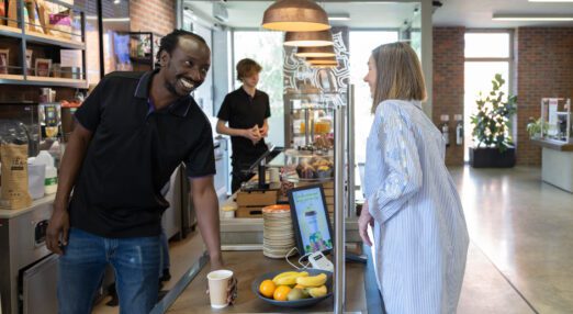 A man in the cafe, serving a customer