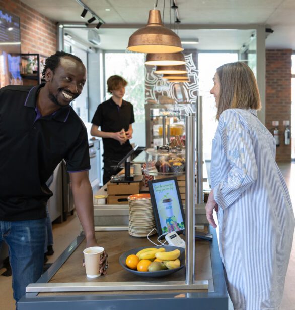 A man in the cafe, serving a customer