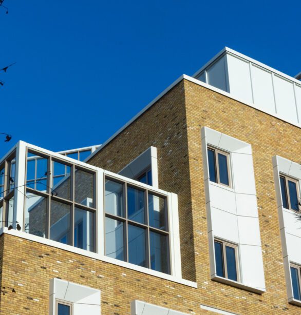 Exterior upper levels of Pears Maudsley Centre, showing a brick building, windows and balcony