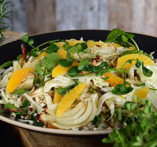 A salad of fennel with a few thin orange slices and some herbs