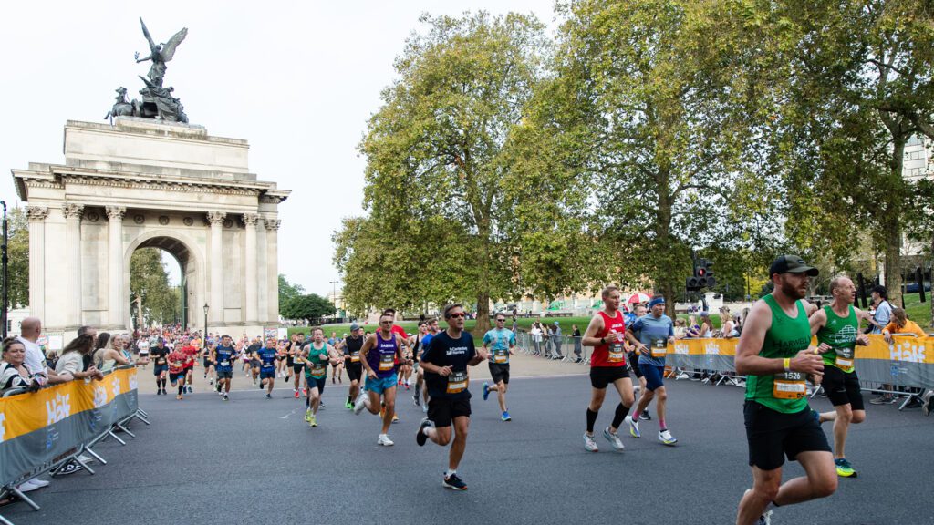 Runners in a race, running along the road from the Admiralty Arch on the Mall
