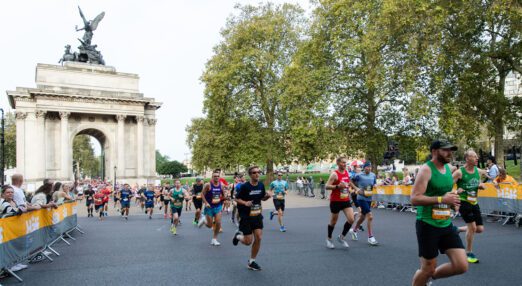 Runners in a race, running along the road from the Admiralty Arch on the Mall