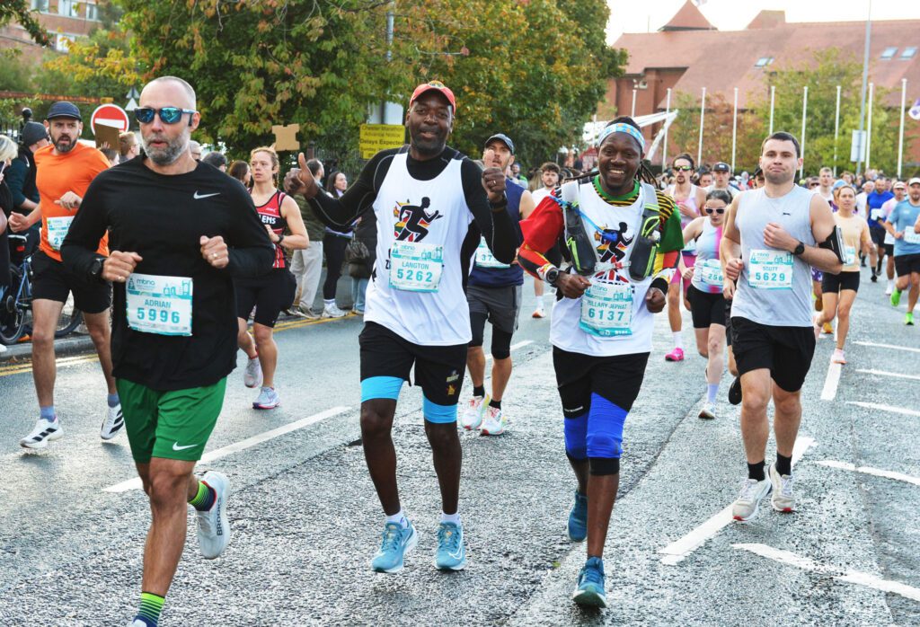 Runners in the Chester Marathon, smiling and laughing for the camera