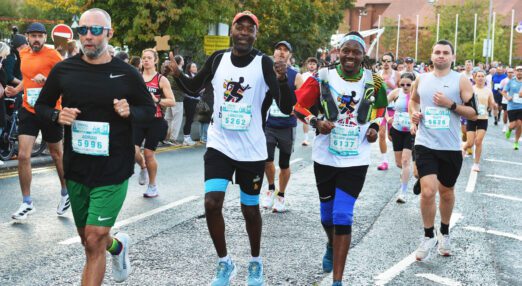 Runners in the Chester Marathon, smiling and laughing for the camera
