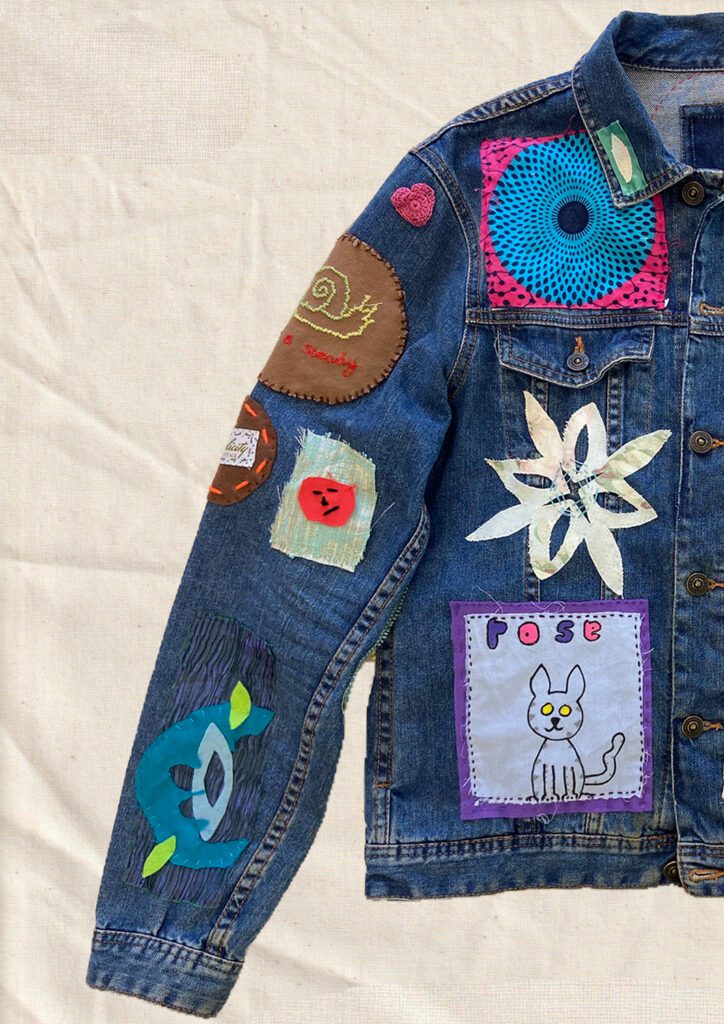 Denim jacket with various colourful patches sewn on