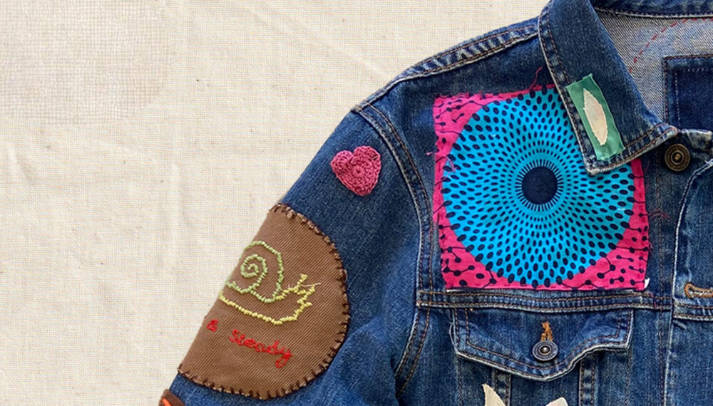Leather jacket covered in a variety of patches